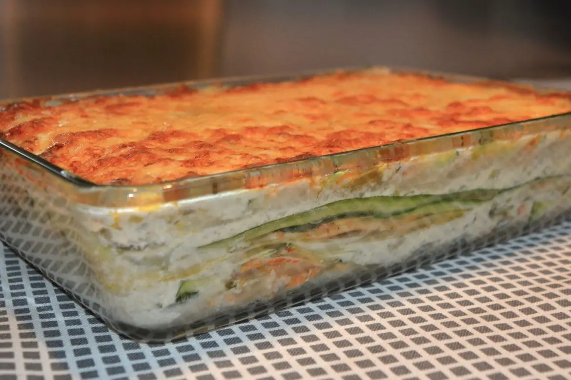 A lasagna in a glass dish on a table, possibly used as a freezer meal