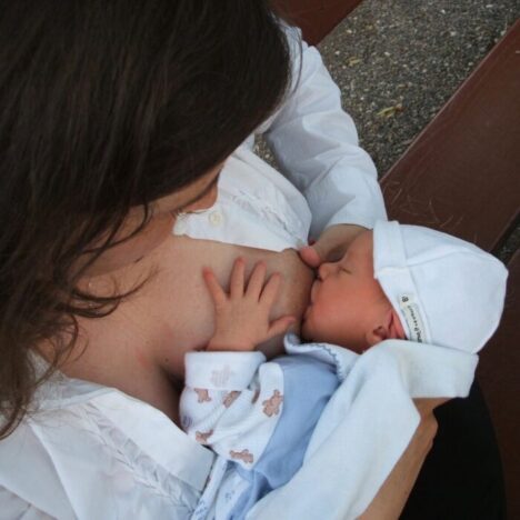 A woman breastfeeding a newborn baby