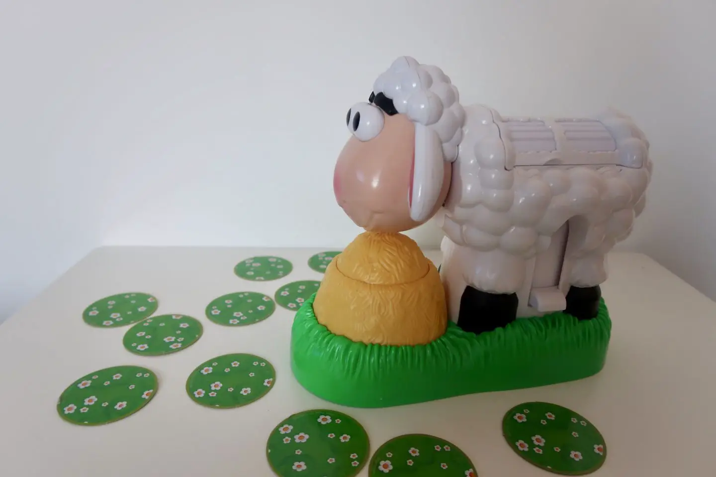 BaaBaa Bubbles Game, a plastic sheep surrounded by round, green card tiles 