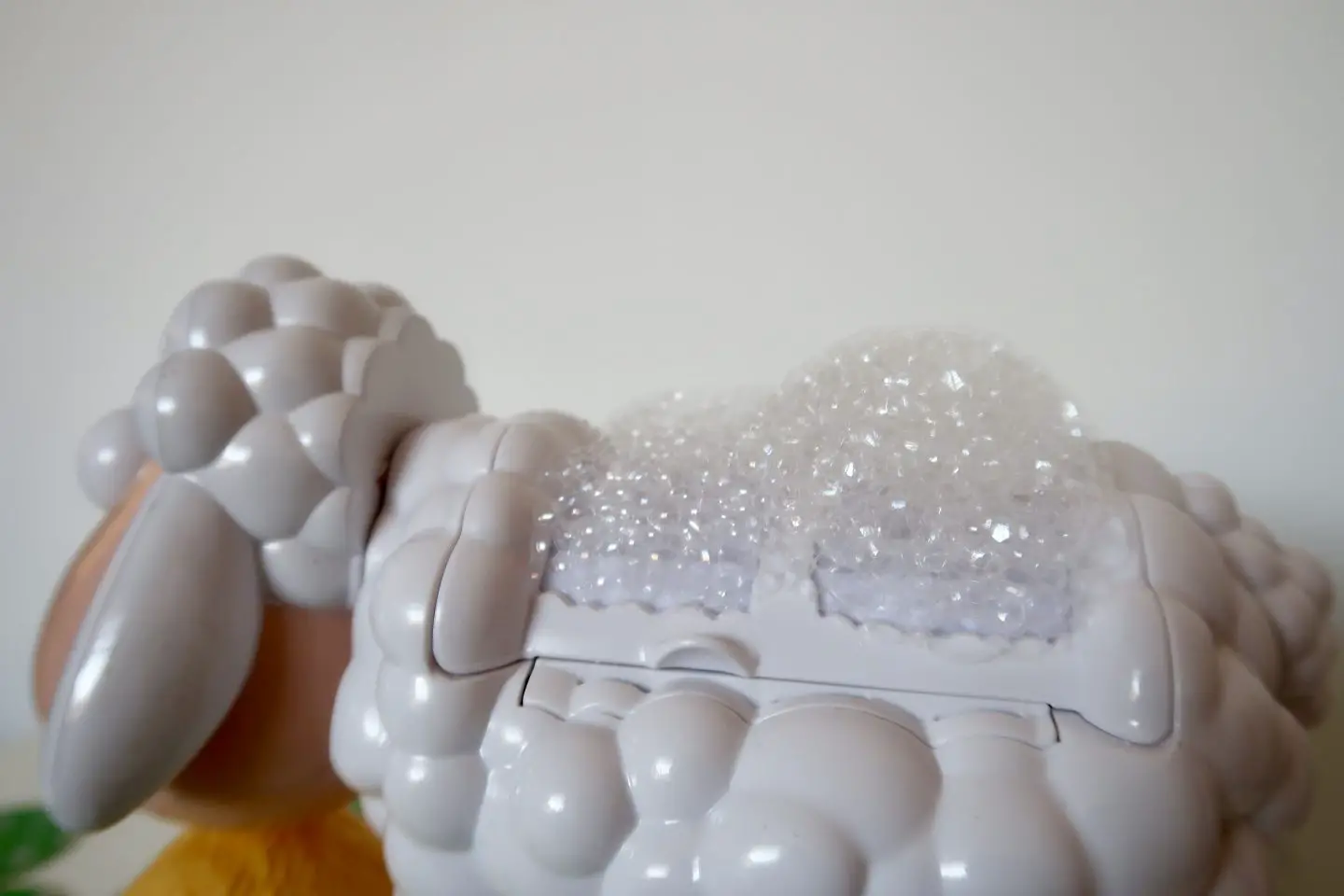 The back of a plastic sheep with bubbles all over it