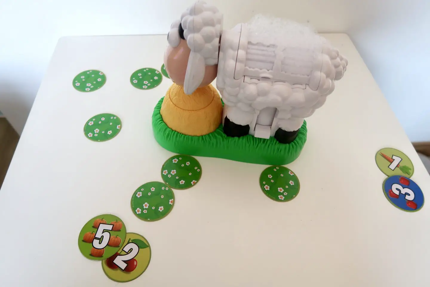 BaaBaa Bubbles sheep surrounded by green tiles, plus some tiles turned over each with a number on them