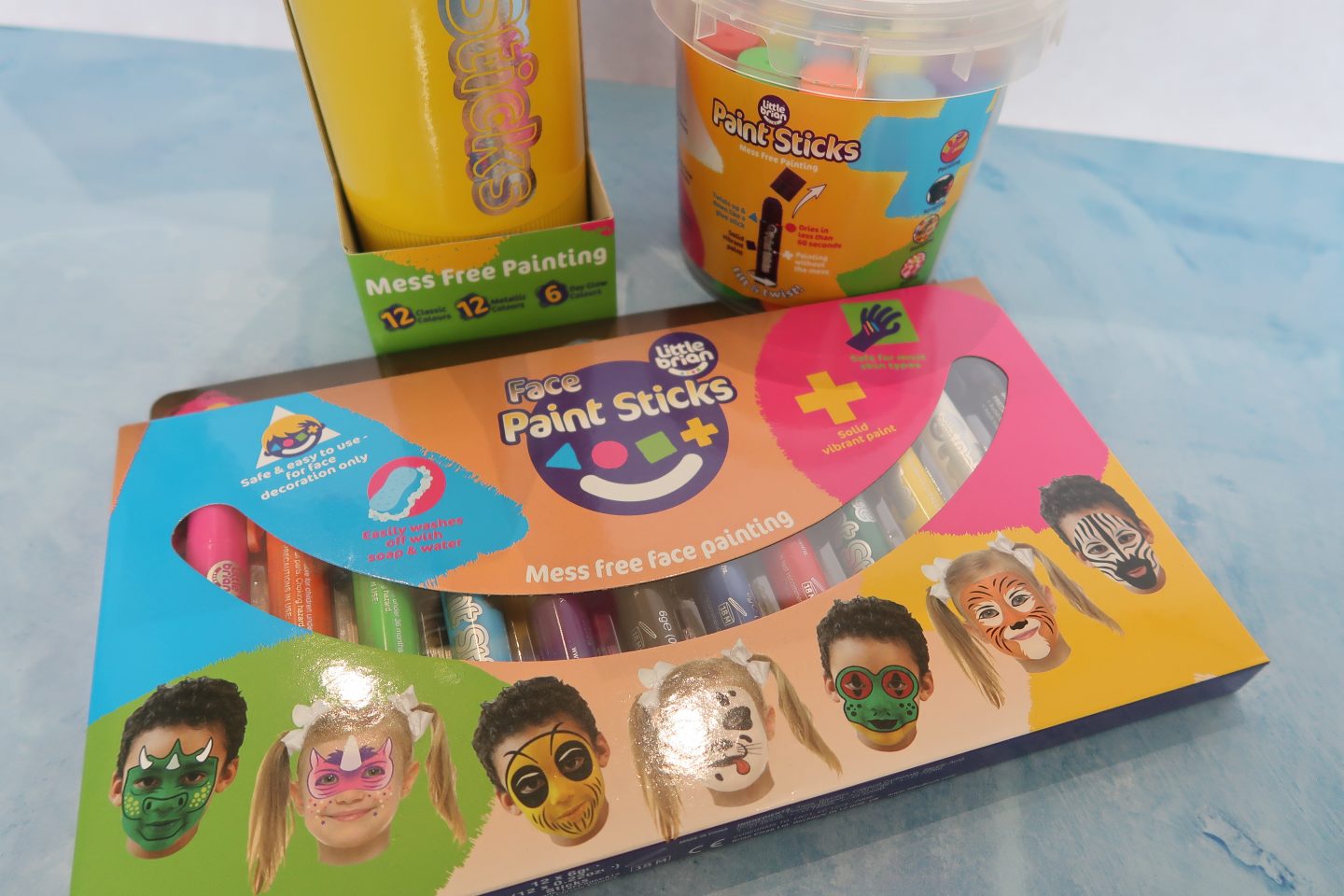Little Brian face paints and paint sticks in their packaging