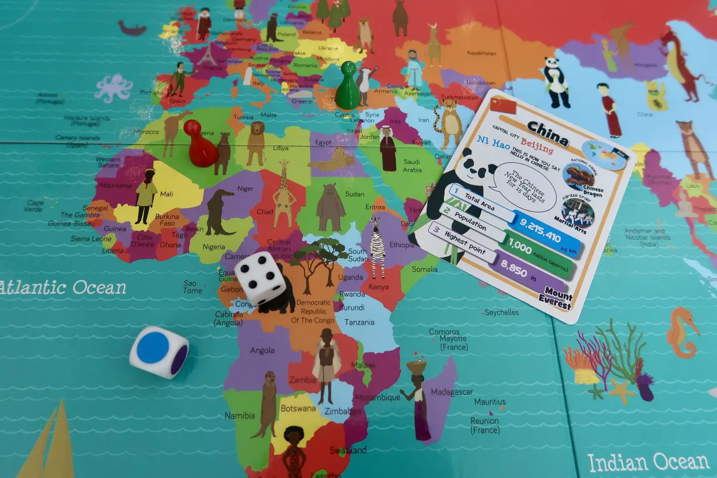 A board game with a world map on it with multicoloured countries