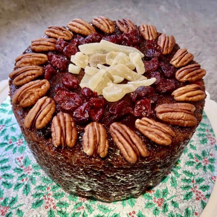 Christmas cake decorated with walnuts, cranberries and stem ginger