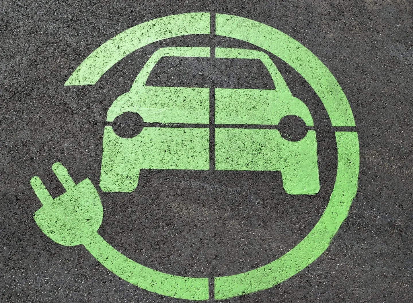 An electric car charging symbol in green
