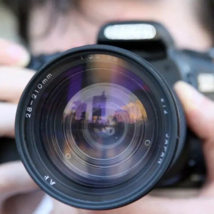 The lens of a black dslr camera