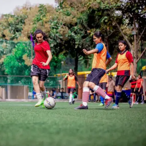 A group of girls playing football outside