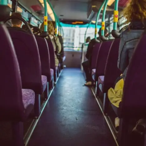 Looking down the centre of a bus with seats on either side