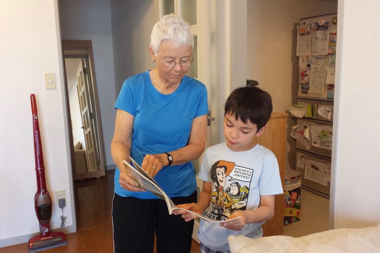 A grandmother and grandson looking at a book