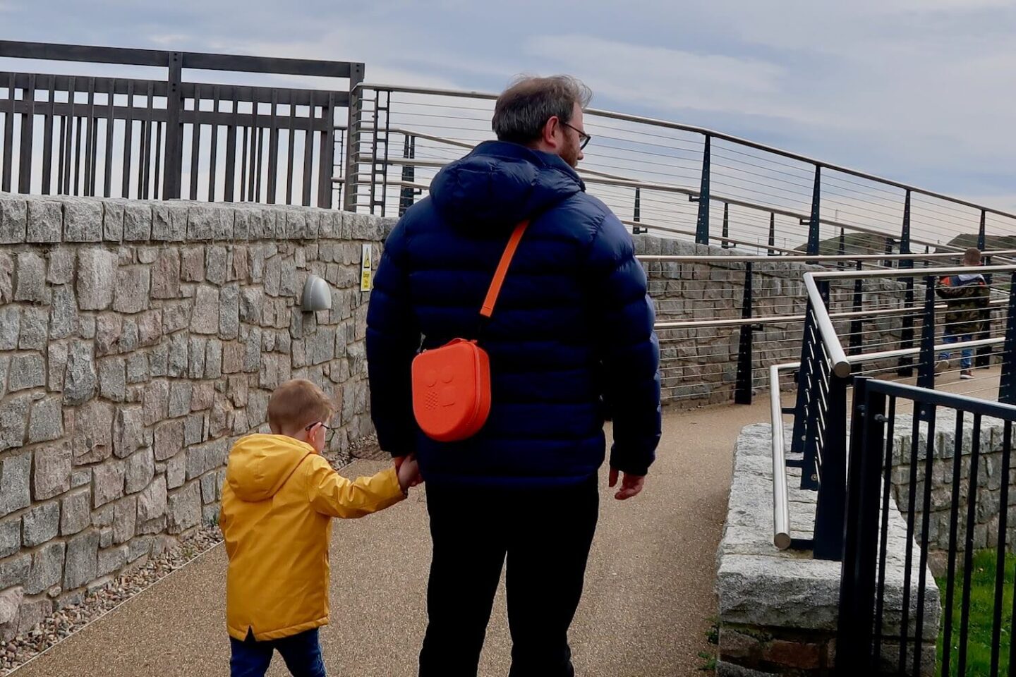 A man and young son walking hand in hand