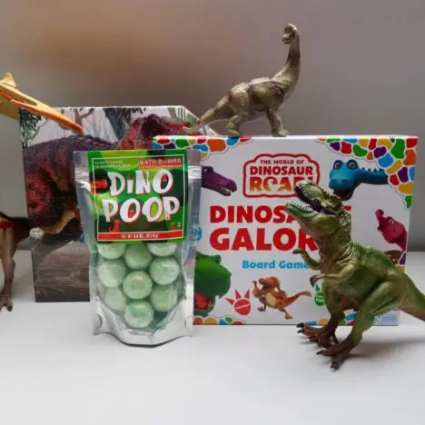 Dinosaur themed games and toys surrounded by plastic dinosaurs