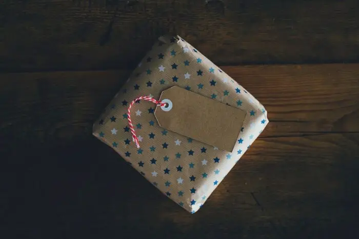A present covered in brown wrapping paper with blue and white stars on it