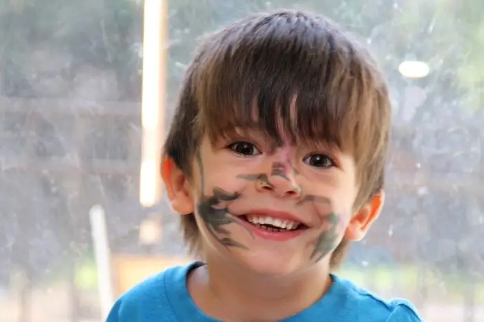 A little boy with pen drawn on his face